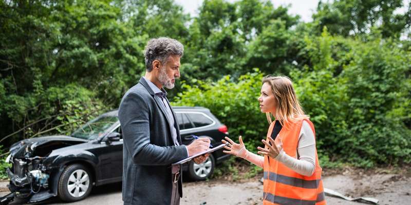 insurance agent talking to a woman driver