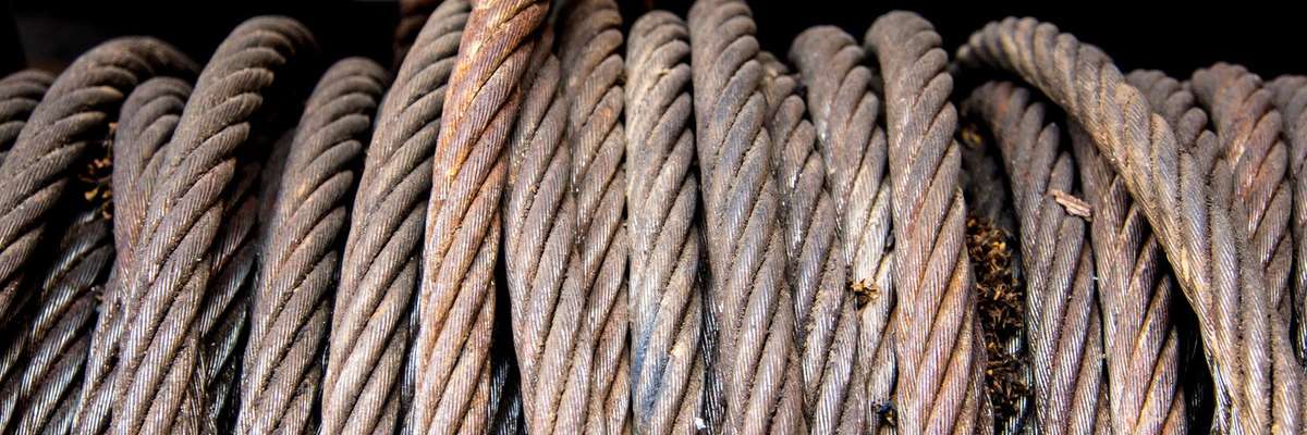 Old sling cable of electric winch in front of 4wd car