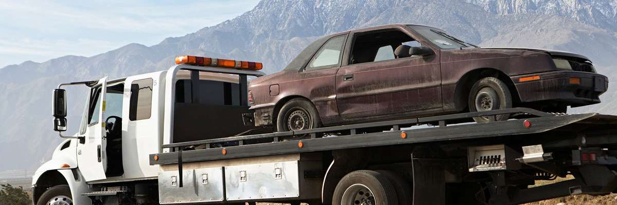 Broken car on tow truck